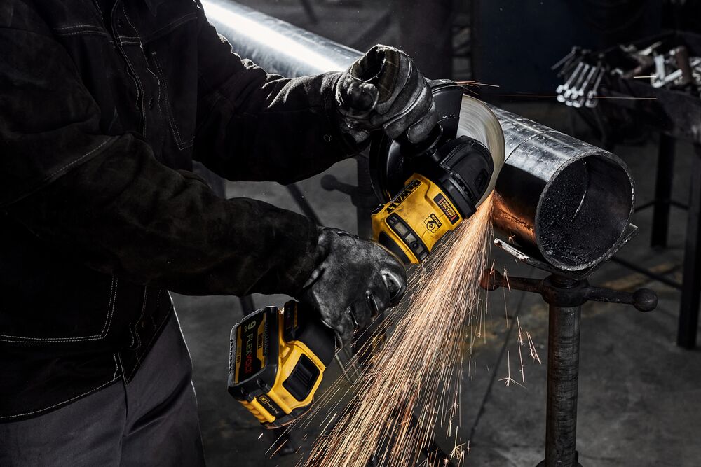 7 INCH BRUSHLESS CORDLESS GRINDER WITH KICK BACK BRAKE being used for cutting metal pipe.