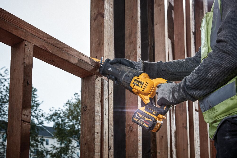 20V MAX* XR(R) reciprocating saw with FLEXVOLT(R) battery cutting through wood beam