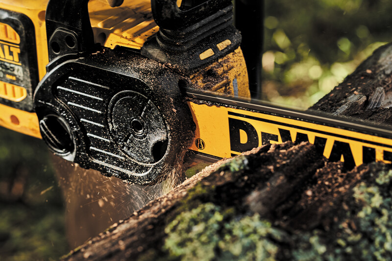 Close up of the cordless chainsaw sawing through a log.